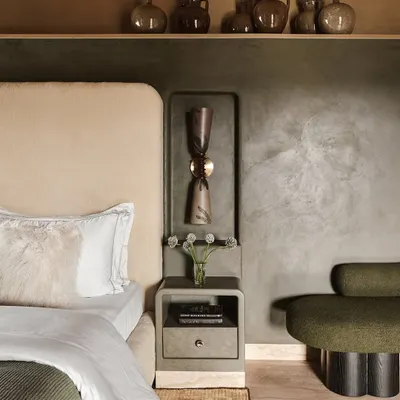 A close-up of a bedroom in the Embassy 821 project, where we layered textures and earthy tones. The lime-washed walls, plush olive green seating, and curated pottery create a calm, Wabi-Sabi inspired atmosphere.