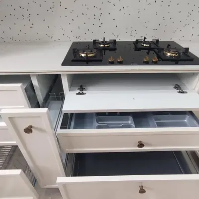 Functionality is key in a modular kitchen. This photo shows the different types of storage I incorporate, including cutlery trays, pull-out drawers, and spice racks, all neatly organized.