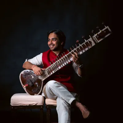 This portrait captures the happiness I feel when I play the sitar. My classes are designed to be enjoyable, helping you connect with the instrument and find your own unique musical voice.