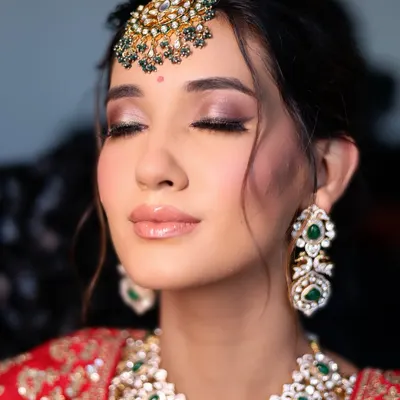 The essence of soft glam. A beautiful close-up showing a perfectly blended smokey eye, glossy nude lip, and radiant skin.