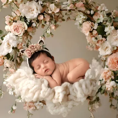 A magical floral swing setup for a sleeping newborn. I use props like this to create dreamy, artistic portraits of your baby girl.