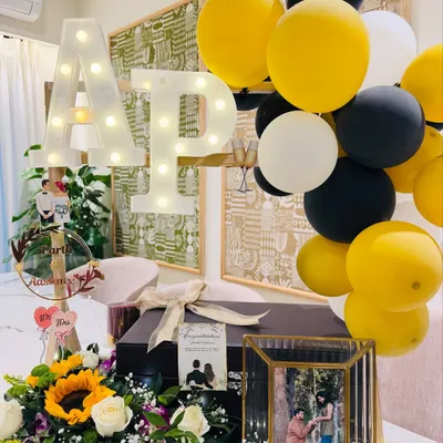 A wedding gift as timeless as their love. This black and gold themed hamper features the couple's light-up initials, a framed photo of their proposal, and a bouquet of sunflowers to symbolize a bright future together.