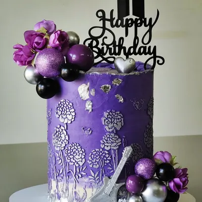 A cake for the BTS army. This design is in the signature purple, with a silver floral bas-relief texture, a guitar accent, and the iconic BTS logo topper, making it a perfect tribute to the band.