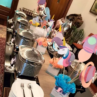 A whimsical "Unicorns and Space" themed buffet for a kid's birthday party. The menu is packed with child-friendly favorites like pasta, sliders, and idli.