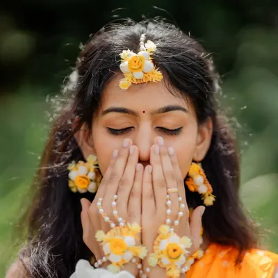 A close-up of Chandana's Haldi makeup. I used soft, warm tones on the eyes and skin to give a sun-kissed glow that perfectly matches the yellow theme and floral accessories of the ceremony.