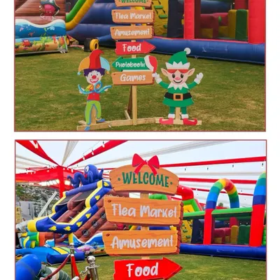 Directional signs for a large Christmas carnival, pointing guests towards the Flea Market, Amusement rides, Food stalls, and Games. I handle all aspects of large-scale event management.