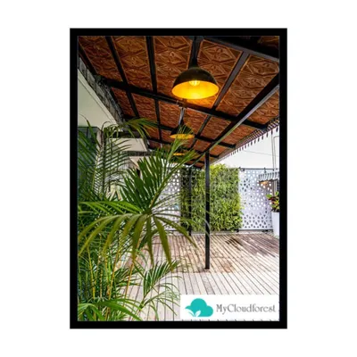 This image highlights the ambient lighting and ceiling detail of a covered terrace I designed. The warm pendant lights illuminate the wooden deck below, while a vertical garden and privacy screen in the background add layers of texture and greenery to the overall design.