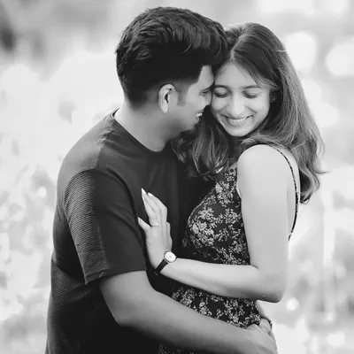 A joyful and candid black and white portrait of Anjali and Platini. Monochrome is perfect for capturing pure emotion and laughter without the distraction of color.