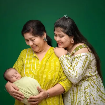 A truly priceless photograph capturing three generations of love. The grandmother holding her new grandchild, with the proud mother looking on, is a powerful and emotional story in a single frame.