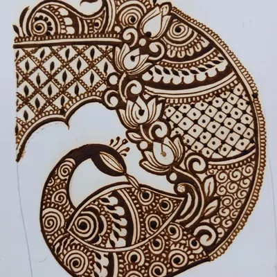 Practicing an intricate peacock startup for a bridal design. Working on paper helps me perfect the flow and details before applying it to a client's hands.