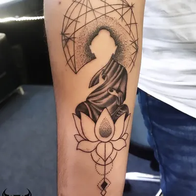 This design uses a silhouette of Buddha set against a geometric background, seated on a lotus. It’s a modern take on a classic spiritual symbol, representing peace and enlightenment.