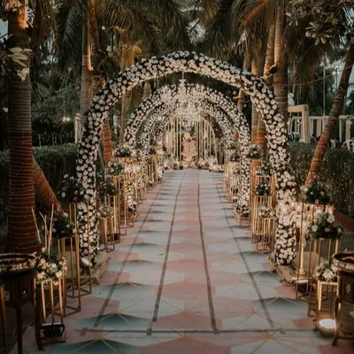 I designed this grand entrance tunnel with a series of floral arches, creating a breathtaking walkway for guests. The path is lined with floral stands, and the entire structure is lit to create a magical, immersive experience.