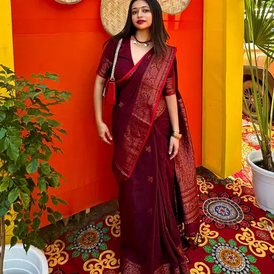 A full-length view of my Durga Puja look, featuring a rich maroon cotton Benarasi saree. The right drape and accessories make this traditional saree perfect for pandal hopping.
