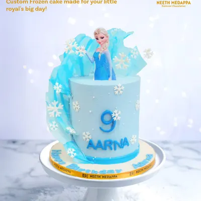 Frozen birthday magic for Aarna's ninth birthday. This cake features an elegant Elsa, sugar snowflakes, and a beautiful sail of pulled sugar.