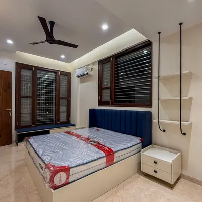 This kid's bedroom is designed to grow with the child. The calming navy headboard creates a perfect environment for focused play and restful sleep, while the unique hanging shelves add a touch of modern fun.