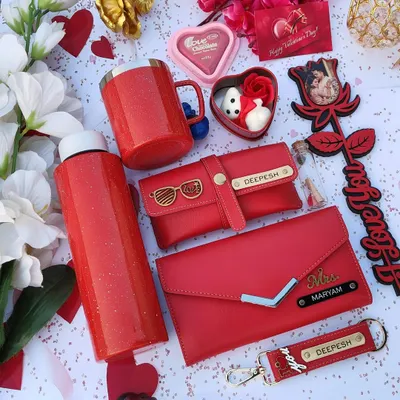 This premium Valentine's hamper in sparkling red is the ultimate gift of love. It includes a personalized sparkle flask and mug, a custom wallet and eyewear case, a photo rose stick, and other romantic goodies.