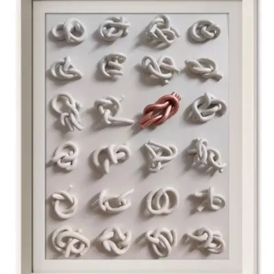 This is my artwork titled 'KNOTS'. Each of the 24 white knots symbolizes a negative trait we might possess. The single copper knot represents the one we are actively working to untie, symbolizing the journey of self-improvement.