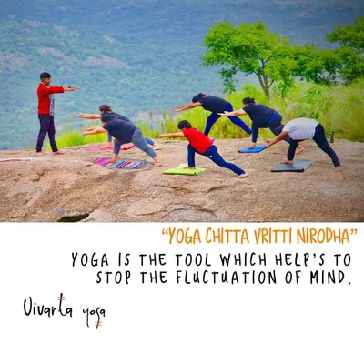 Guiding a group through Virabhadrasana (Warrior Pose) on a rocky plateau. This is an example of "Yoga Chitta Vritti Nirodha", using the physical practice to stop the fluctuations of the mind and find stability.