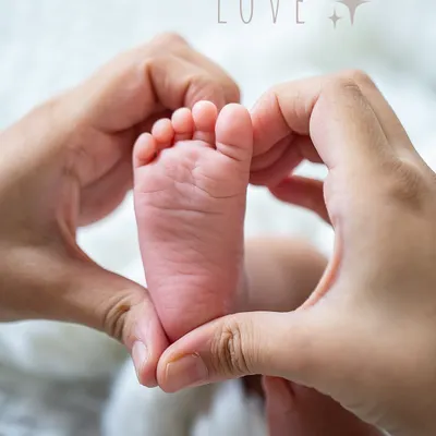 There is so much love in the smallest details. Parents' hands forming a heart around their newborn's tiny foot is a simple, powerful image of family love.