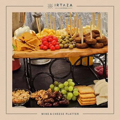 A beautiful grazing platter perfect for a corporate wine and cheese event. The rustic wooden board is laden with cheeses, crackers, nuts, fruits, and olives, creating an abundant and inviting display.
