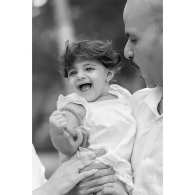 A timeless black and white version of a father and daughter's laugh. Stripping away the color focuses the viewer's attention on the pure emotion and connection in this family portrait.