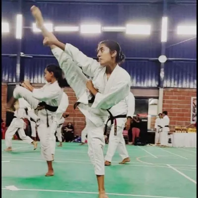 One of our dedicated senior students demonstrating a flawless high kick, a result of years of training in flexibility and technique.