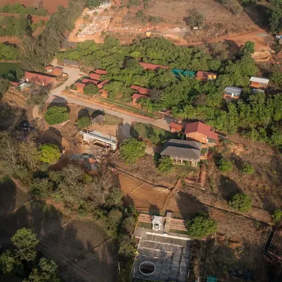 An aerial view of the 14-acre site for the Kaivalyam Yoga Ashram in Belagavi. The master plan is carefully laid out to respect the 120-foot slope and maximize views of the Western Ghats.