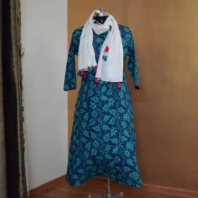 This A-line cotton kurti in shades of blue and turquoise features a lovely floral block print. I've paired it with a simple white dupatta with colorful tassels for a cheerful, everyday look.