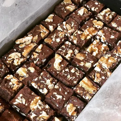 A freshly made tray of my Walnut Chocolate Fudge, cut into perfect bite-sized squares. I make these in small batches to ensure they are perfectly gooey and decadent every time.