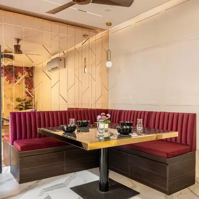 To maximize a compact area, I designed this custom booth dining setup. It not only provides comfortable seating but also includes hidden drawers for storage, making it a dual-function space for meals and work.