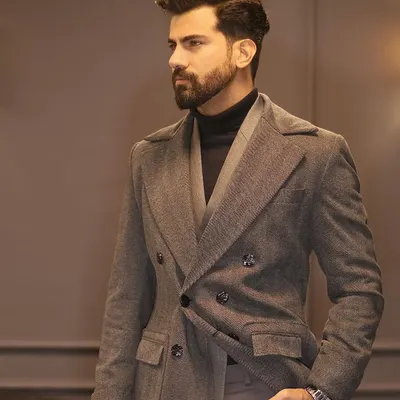 Wrap yourself in sophistication with our tailor-made long coat. Crafted from a textured grey fabric, this double-breasted overcoat is the perfect final layer for a polished winter look.