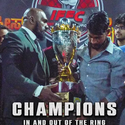 Champions in and out of the ring. Here I am awarding a trophy at our own Iron Fist Fighting Championship, an event we created to give fighters a platform to showcase their skills.