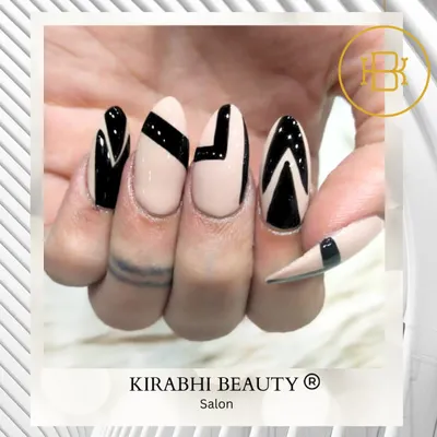 Beyond tattoos, our talented team also creates stunning nail art. This is an example of a bold, geometric design with black polish on a neutral base for a modern look.