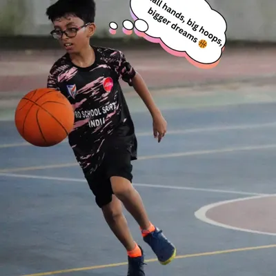 Here, a young player practices his dribbling technique during one of our group sessions. We emphasize ball control and coordination, which are essential beginner basketball skills for any aspiring athlete.