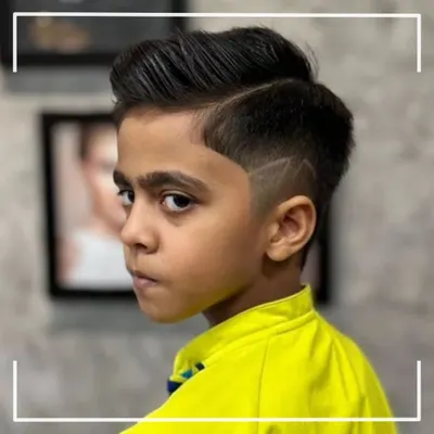 This young man is rocking a super cool haircut with a sharp side design. We love creating fun and trendy styles for our little clients.