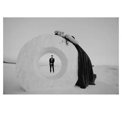 An artistic black and white shot at a mineral quarry, using a large stone ring to frame the groom. This creative composition results in a powerful and memorable image.