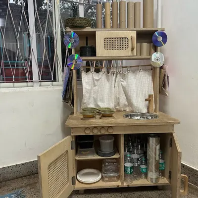 Welcome to the Playmaker's Lab, our end-of-year tradition. We pack away the toys and replace them with recycled treasures like cardboard, bottle caps, and fabric, inviting children to reimagine waste and create with purpose.