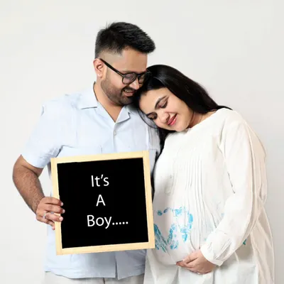 It's a Boy! This couple shares their happy news with a simple chalkboard sign. This is a classic and heartfelt way to announce your baby's gender.