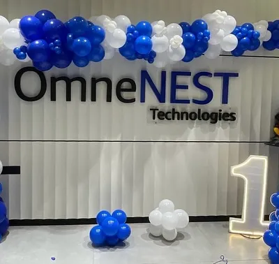 Celebrating a corporate anniversary for OmneNEST Technologies. We created a grand entrance with a full balloon arch in the company's blue and white brand colors, complemented by a large "1" LED number to mark their first year.