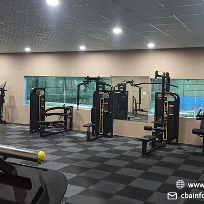 An overview of our on-site gym, featuring a variety of strength and cardio machines. This facility provides a comprehensive fitness solution for our members, allowing them to supplement their on-court training with targeted workouts.