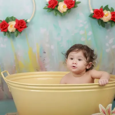 A curious look from a baby in a yellow tub. Our splash sessions are a great way to capture your child's inquisitive nature in a fun, playful setting.