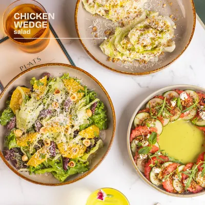 A trio of our seasonal salads. This one highlights the Chicken Wedge Salad, a crisp and refreshing option.