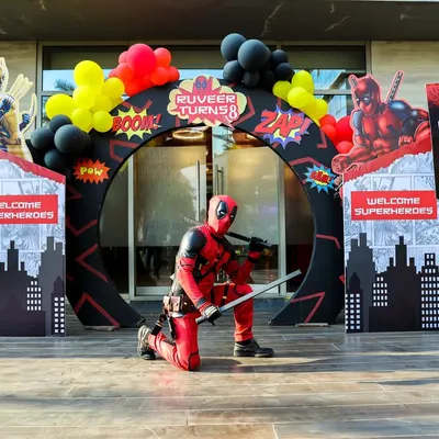 A grand entrance for a superhero. A Deadpool mascot greets guests at this action-packed party entrance, setting the stage for an epic celebration.