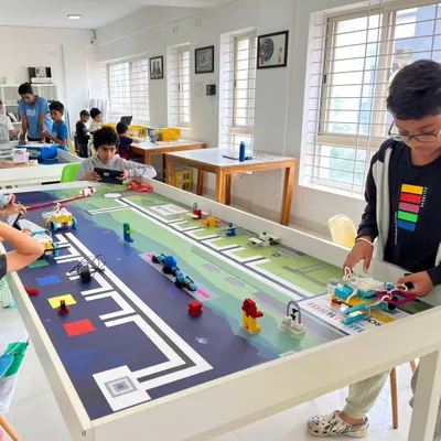 Students at our North Bangalore center are deep in concentration as they prepare their robots for the World Robot Olympiad national round. This hands-on practice is crucial for mastering the competition challenges.