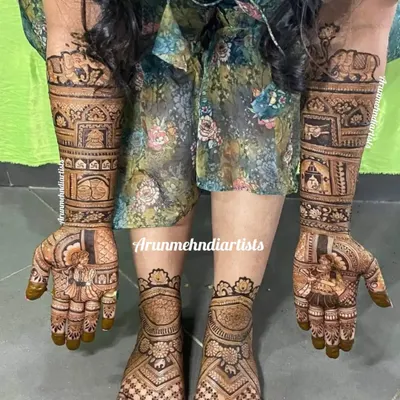 This is a complete bridal mehndi set. The intricate designs on the hands, featuring elephants and architecture, are perfectly complemented by the matching patterns on the feet.