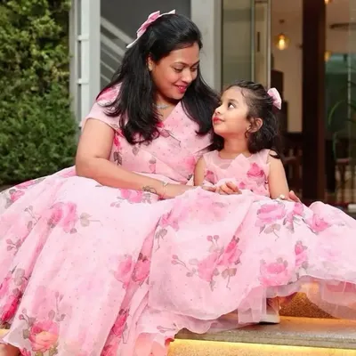 A sweet moment between a mother and daughter in their matching floral gowns. I love seeing my clients enjoy their special outfits together.