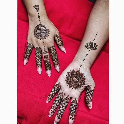 A beautiful mandala design. The pattern is different on each hand, creating a unique and modern look with lotus motifs and geometric finger details.