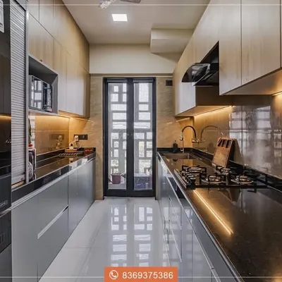 This parallel kitchen layout is a masterclass in efficiency and style. We used a combination of light wood-look upper cabinets and sleek grey lower cabinets, illuminated by continuous under-cabinet LED lighting for a dramatic, modern effect.
