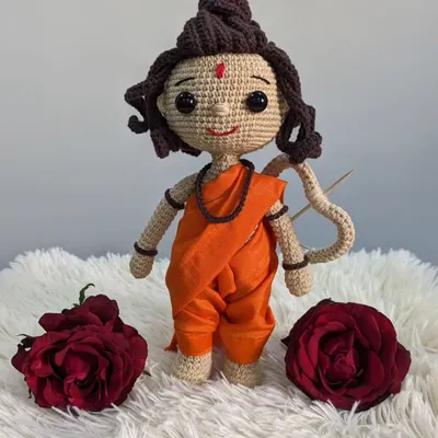 A full-length view of my handmade Shree Ram doll, crafted with saffron-colored robes and holding a bow.
