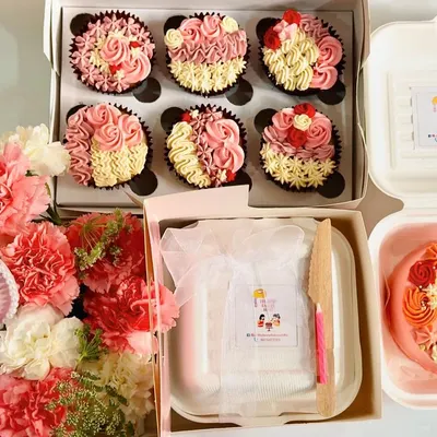 Our full Mother's Day spread. This shows how you can combine our offerings into a beautiful gift, featuring a box of floral cupcakes, a custom bento cake, and a fresh flower bouquet.